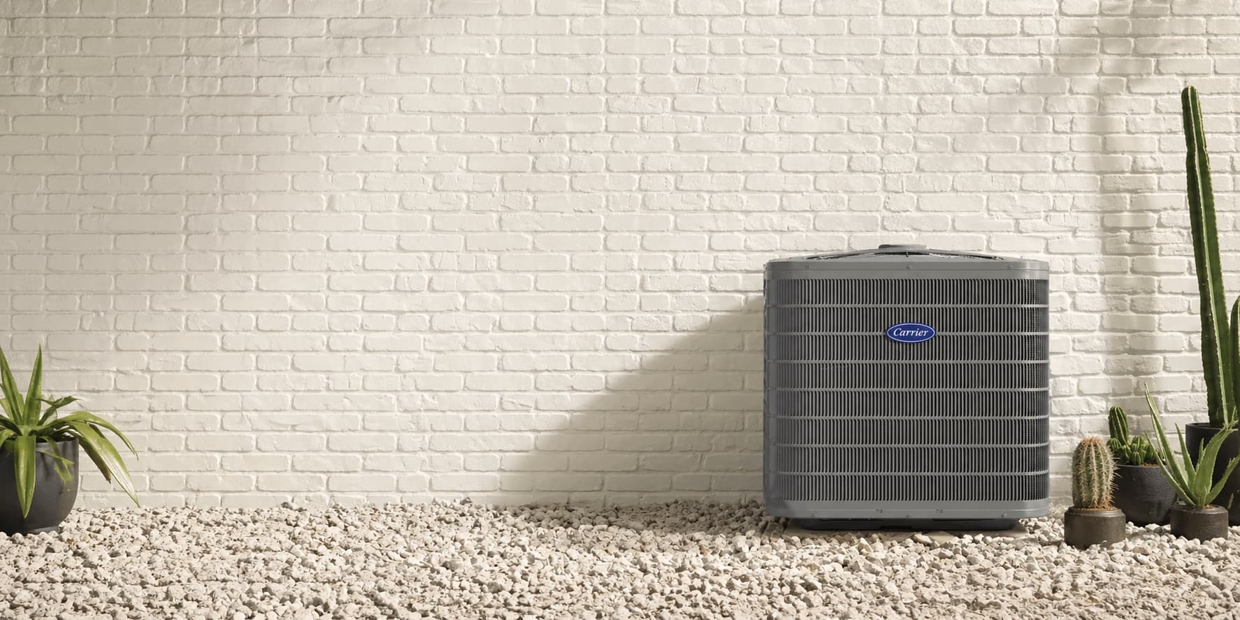Carrier air conditioner installed against a white brick wall